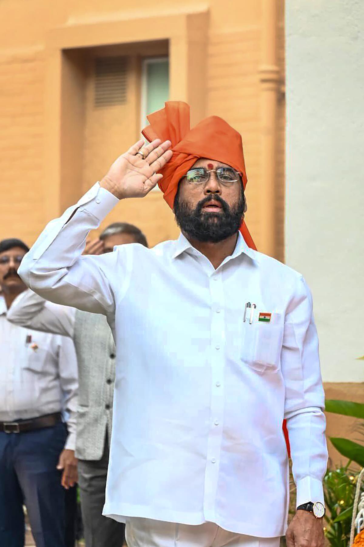 Maharashtra Chief Minister Eknath Shinde salutes after hoisting the national flag during the 74th Republic Day celebrations, at his official residence in Mumbai, on Jan. 26, 2023. 