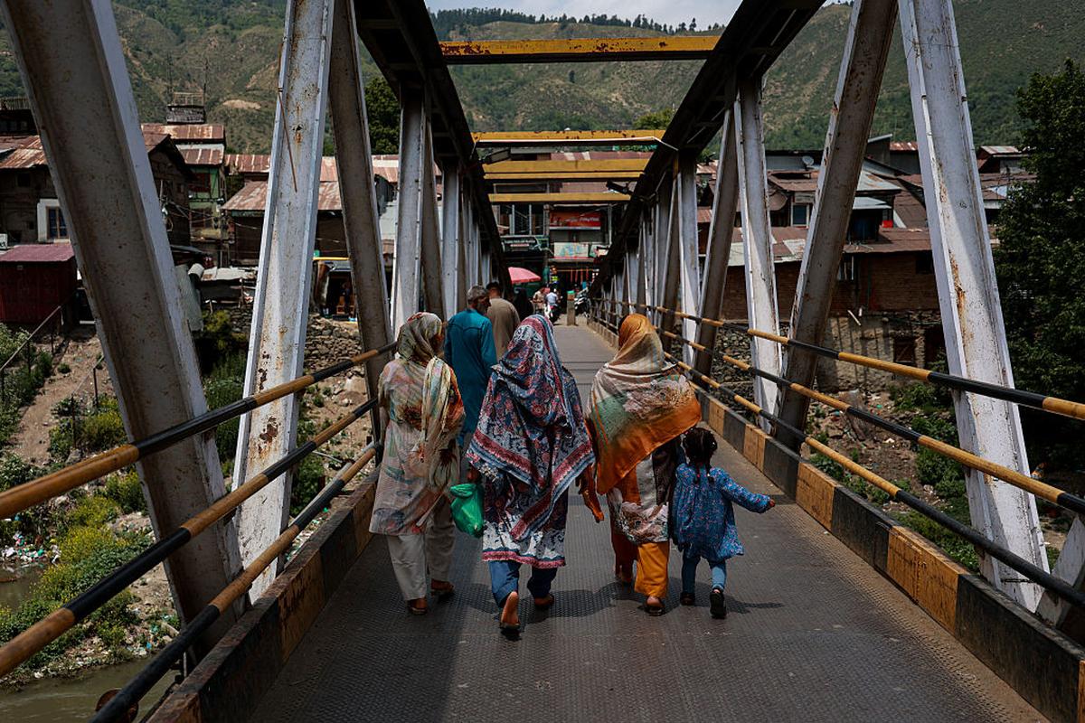 People cross a bridge in Baramulla, Jammu and Kashmir. People cross a bridge in Baramulla, Jammu and Kashmir.
