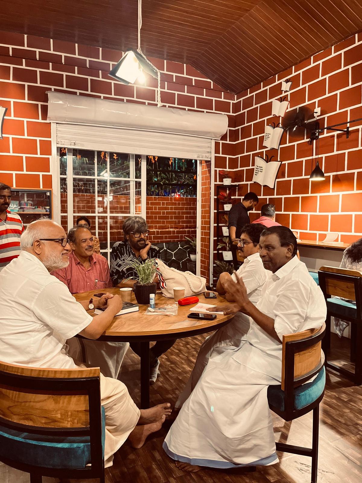 C Rahim, Abraham Mathew, Congress leader PA Salim, Thiruvanchoor Radhakrishnan, MLA, and Politburo member MA Baby are deep in conversation at the Cafe Book Mark