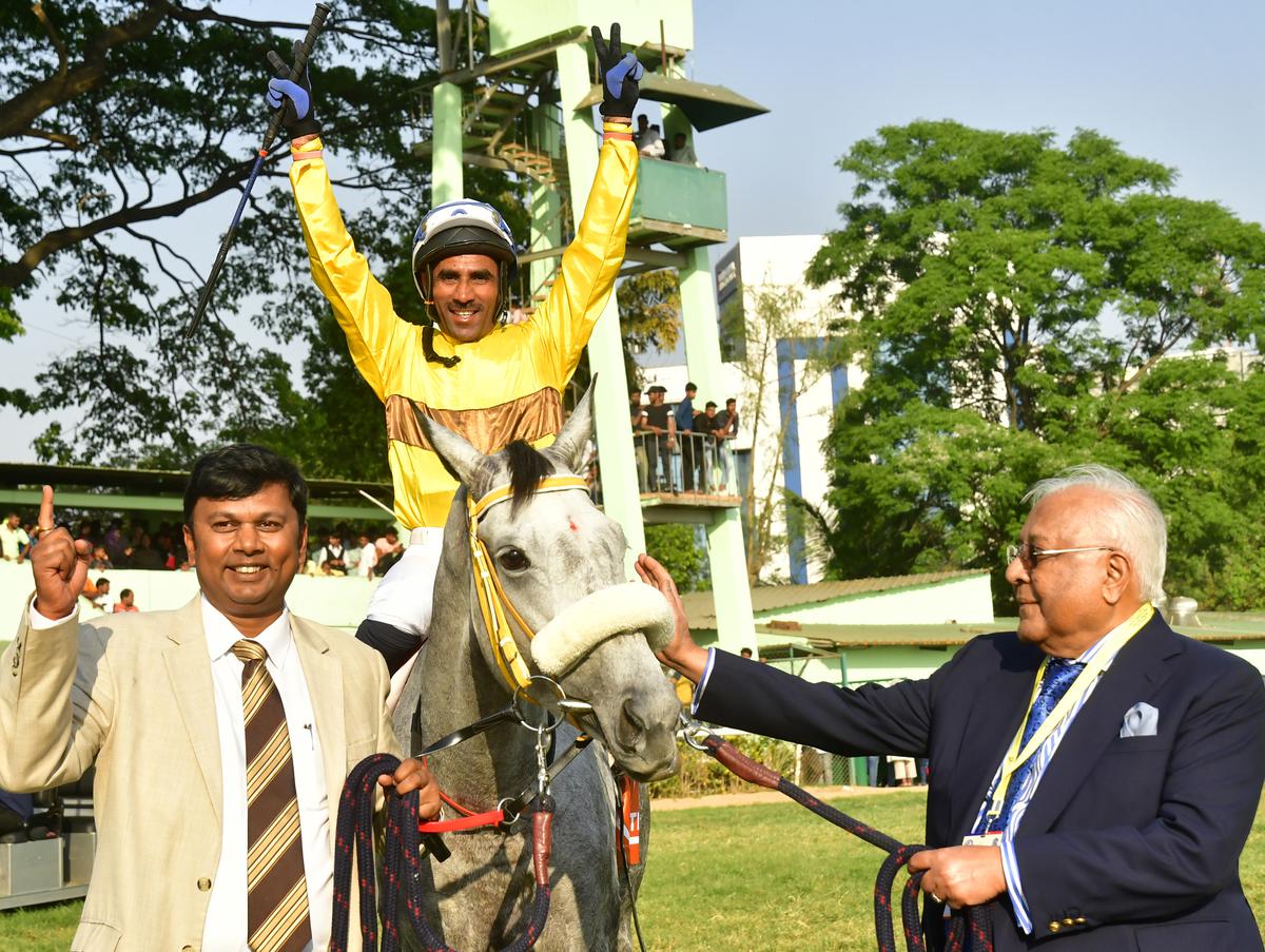 Juliette (C.S. Jodha astride), the oldest horse to win the Invitation Cup, being led in by the proud trainer Karthik Ganapathy gets a pat from the owner A.C. Muthiah.