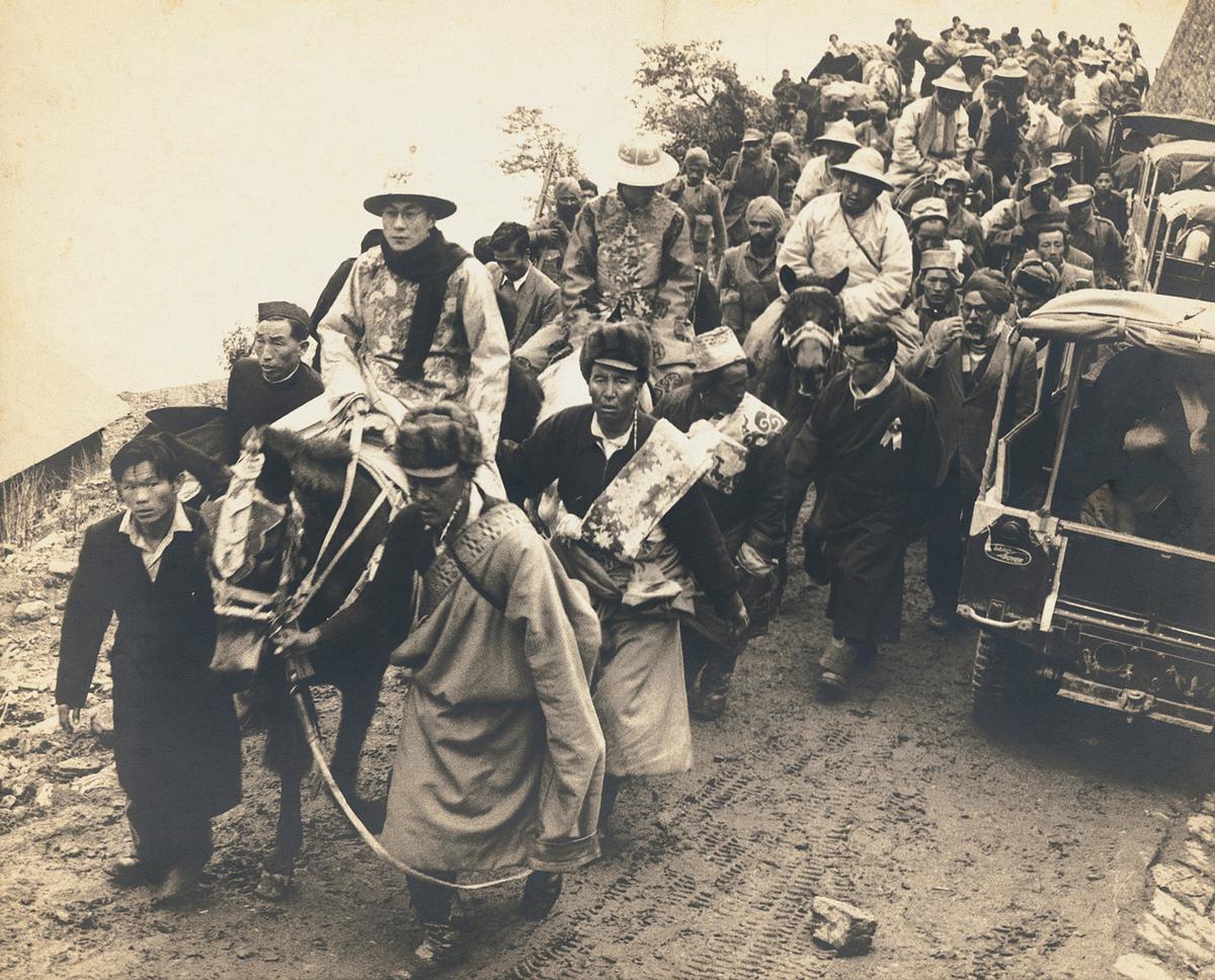 The Dalai Lama in ceremonial dress enters India through a high mountain pass in Sikkim in 1956. 