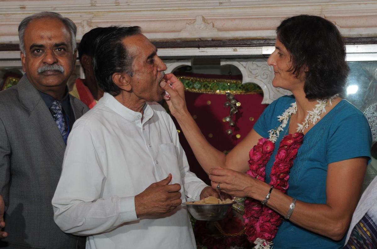 US astronaut Sunita Williams (R)  gives sweets to Dineshbhai Raval, her uncle after performing Hindu rituals at the Dola Mataji Temple, at Jhulasan Village, where she was born, some 50 kms from Ahmedabad on April 4, 2013.  