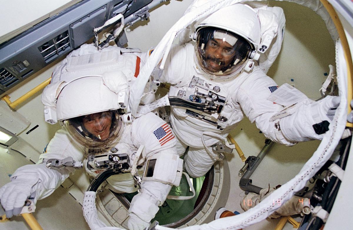 Astronauts Bernard Harris Jr., STS-63 payload commander (right) and Michael Foale, mission specialist, are ready to egress airlock for an extravehicular activity (EVA) on February 9, 1995. 