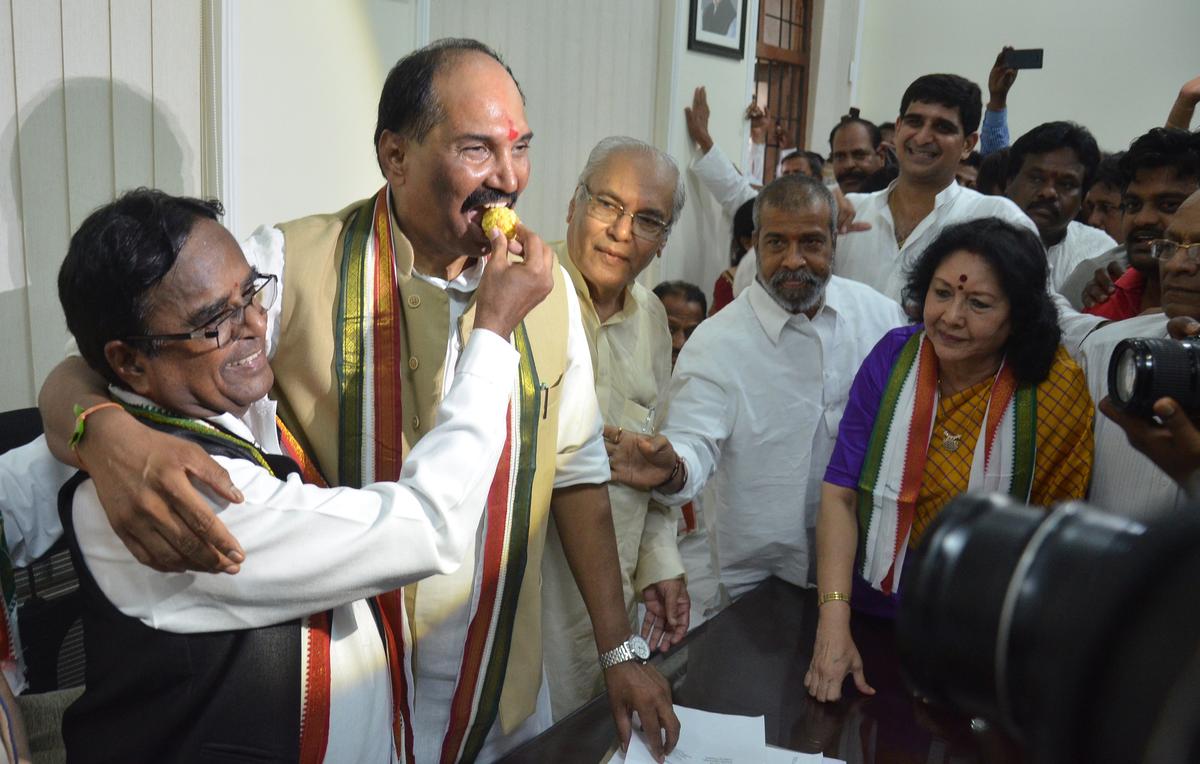 File photo of outgoing Telangana Pradesh Congress Committee (TPCC) president, Ponnala Lakshmaiah, offering sweets to N. Uttam Kumar Reddy on taking charge as the new president of TPCC, in Hyderabad on March 8, 2015.