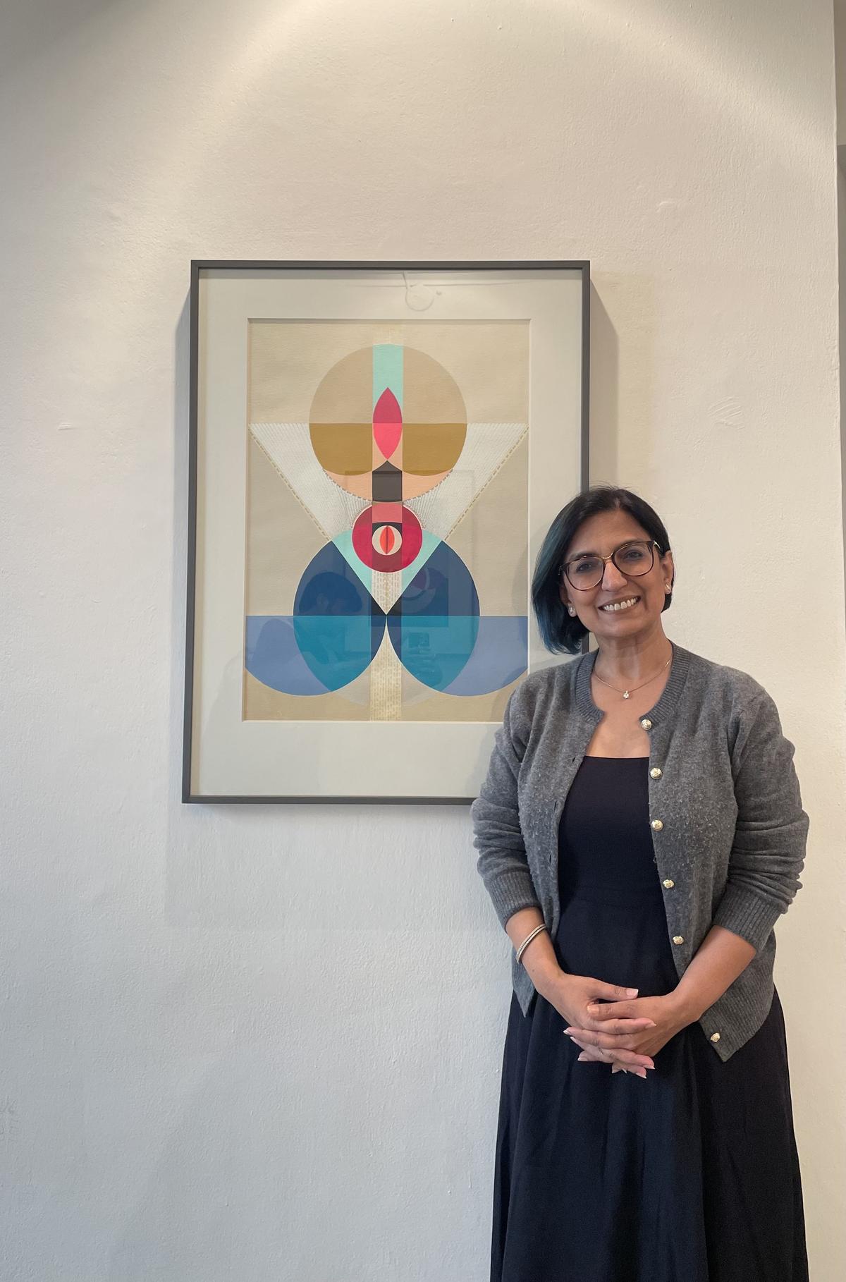 Artist Neerja Chandna Peters with her artwork at her solo exhibition Roopa Bheda - Secrets of Form at Bikaner House, New Delhi