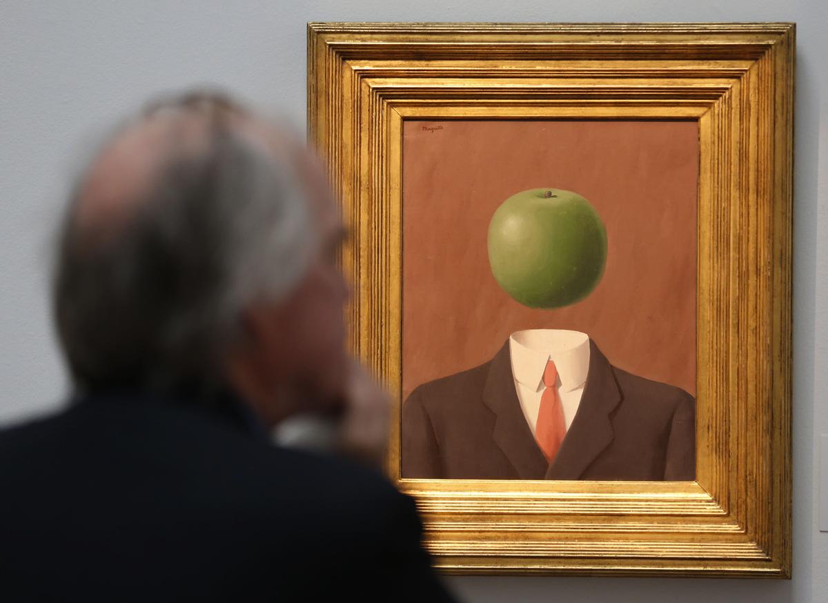 A visitor looks at a 1966 painting ‘L’Idee’ by Rene Magritte on display at the auction house in London. A visitor looks at a 1966 painting ‘L’Idee’ by Rene Magritte on display at the auction house in London.