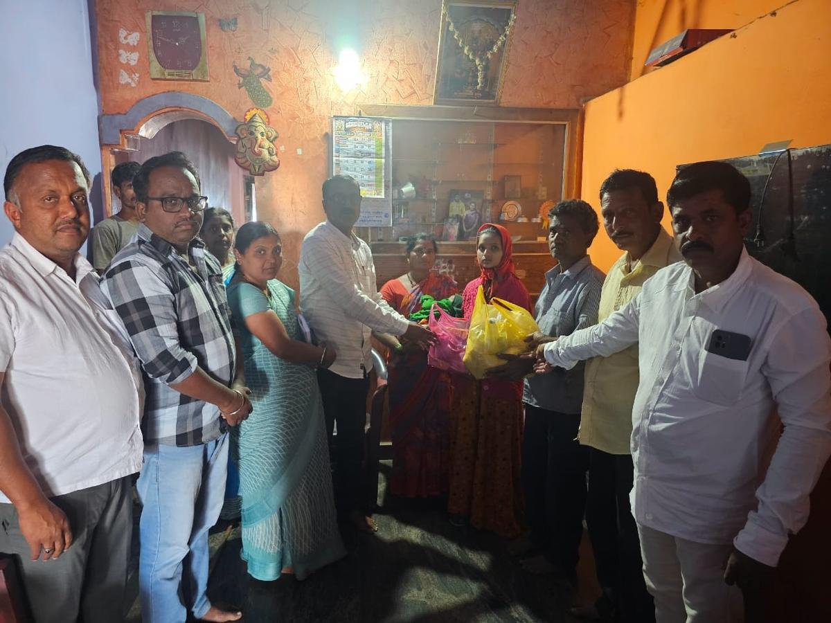 Officers hand over grains and vegetables to the family of farmer Ganapati Lohar, who was evicted from his house for non payment of a housing loan. Minister Lakshmi Hebbalkar intervened to resettle the family in Tarihal in Belagavi on January 24, 2025.