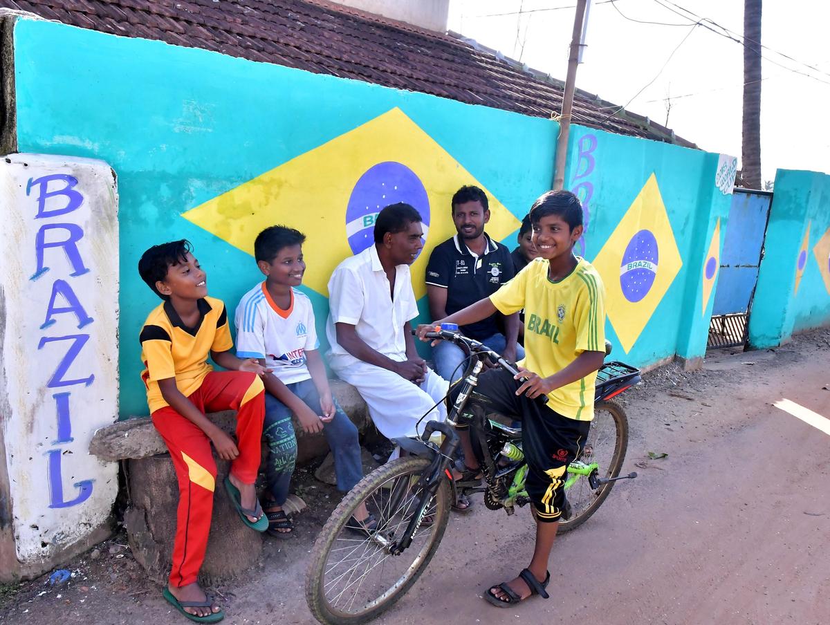 Fans gather in front of a wall painted in Brazil’s colours in Kozhikode during the FIFA World Cup 2018.