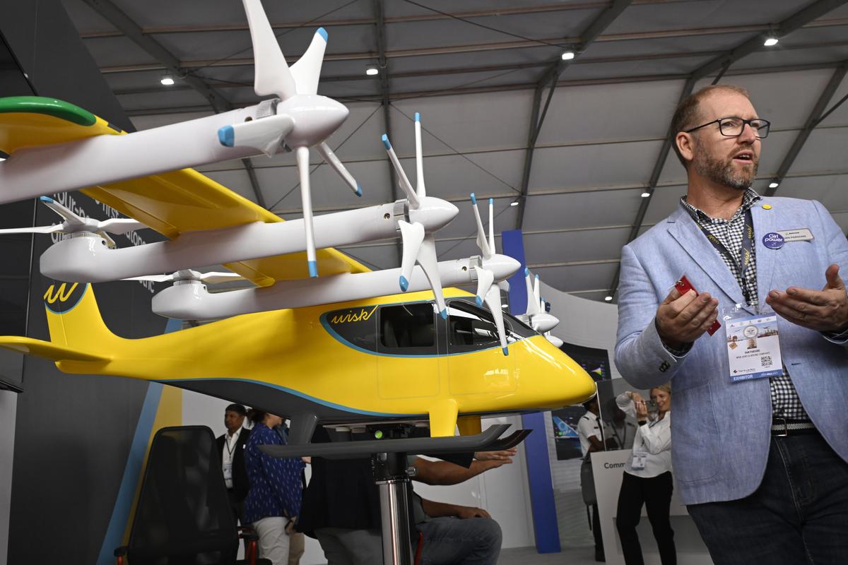 A Wisk eVTOL aircraft model on display as an exhibitor explains its features at the Wings India 2026 aviation show in Hyderabad on Friday (January 30, 2026)