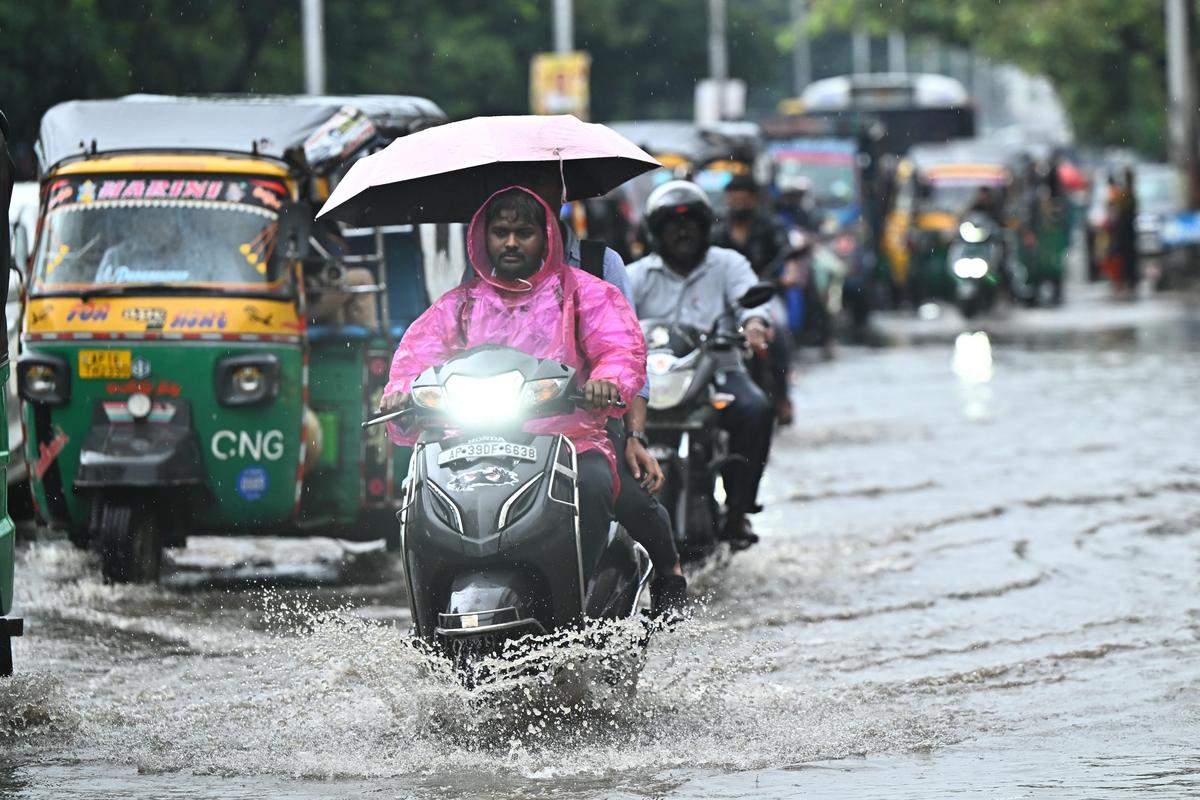 Vehicles passign through a waterlogged road after rain lashed Vijayawada for almost five hours on Thursday.