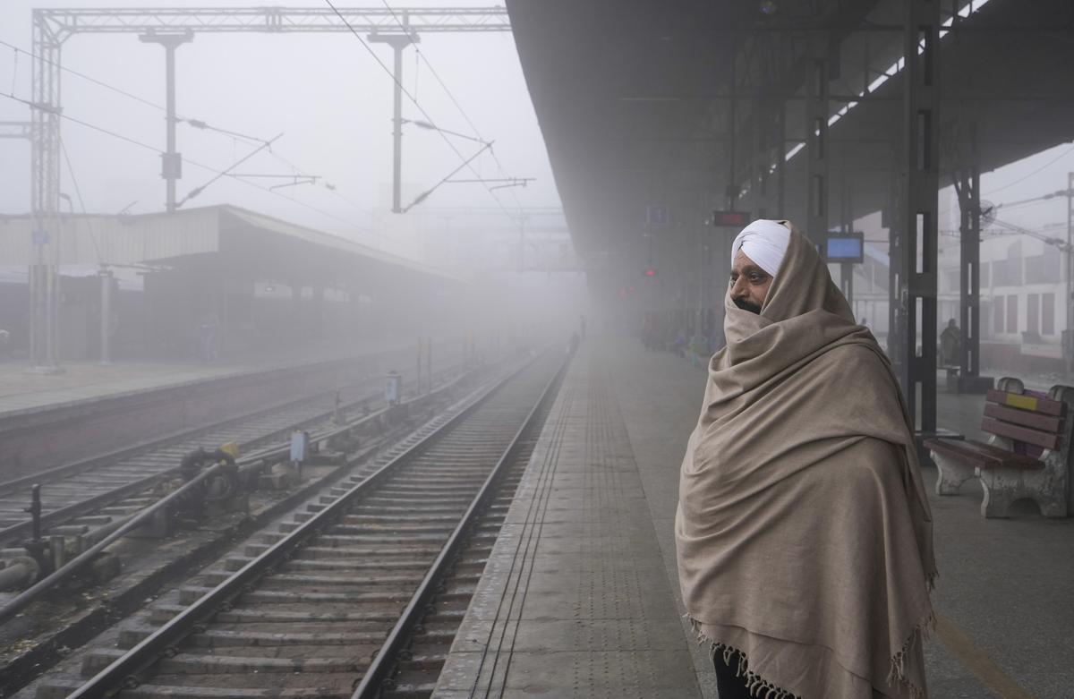 A commuter waits for a train at a railway station amid dense fog during a cold winter morning, in Amritsar, Monday, Jan. 6, 2025.  A commuter waits for a train at a railway station amid dense fog during a cold winter morning, in Amritsar, Monday, Jan. 6, 2025.