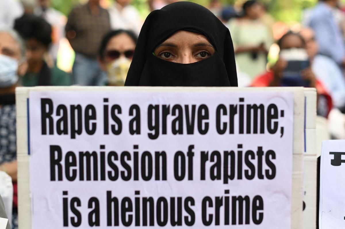 A demonstrator holds a placard at a protest seeking justice for Bilkis Bano, in New Delhi.