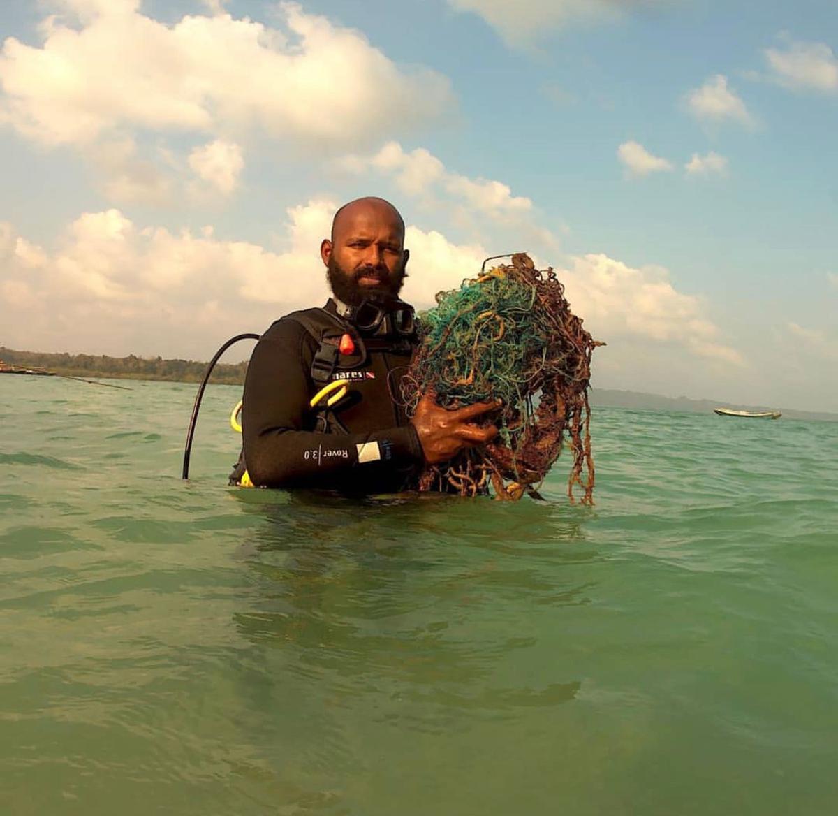 Scuba diver Subhash Chandran with trash collected from seabed at Rushikonda in Visakhapatnam.