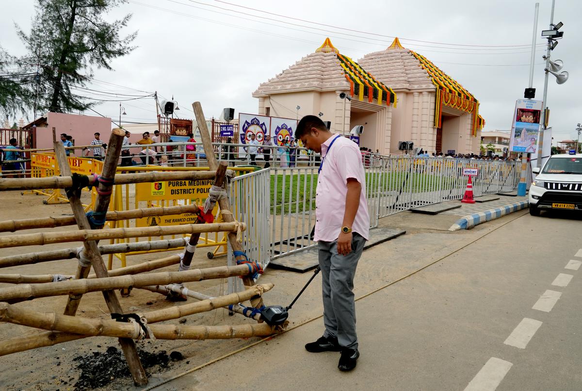 A security personnel inspects outside the Jagannath Dham ahead of Lord Jagannath Rath Yatra, in Digha A security personnel inspects outside the Jagannath Dham ahead of Lord Jagannath Rath Yatra, in Digha