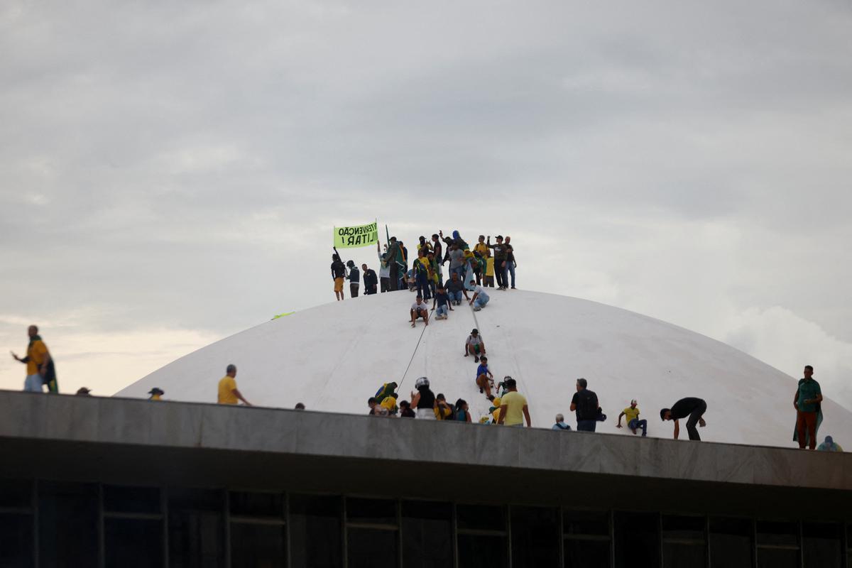Supporters of Brazil's former President Jair Bolsonaro are pictured atop the dome of the National Congress during a demonstration against President Luiz Inacio Lula da Silva, in Brasilia.