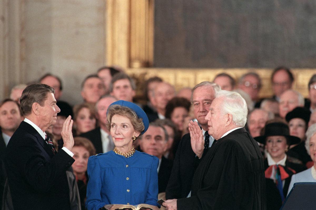 Ronald Reagan is sworn in as 40th President of the United States by Chief Justice Warren Burger beside his wife Nancy Reagan during the inauguration ceremony on January 21, 1985 at the Capitol Rotunda in Washington D.C. 