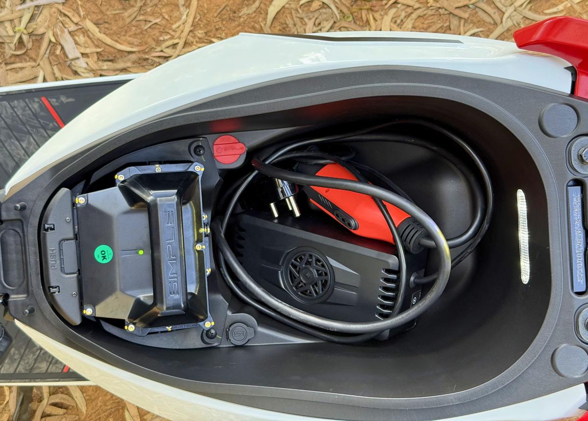 The under-seat compartment is spacious enough to accommodate a full-face helmet or the charging cable