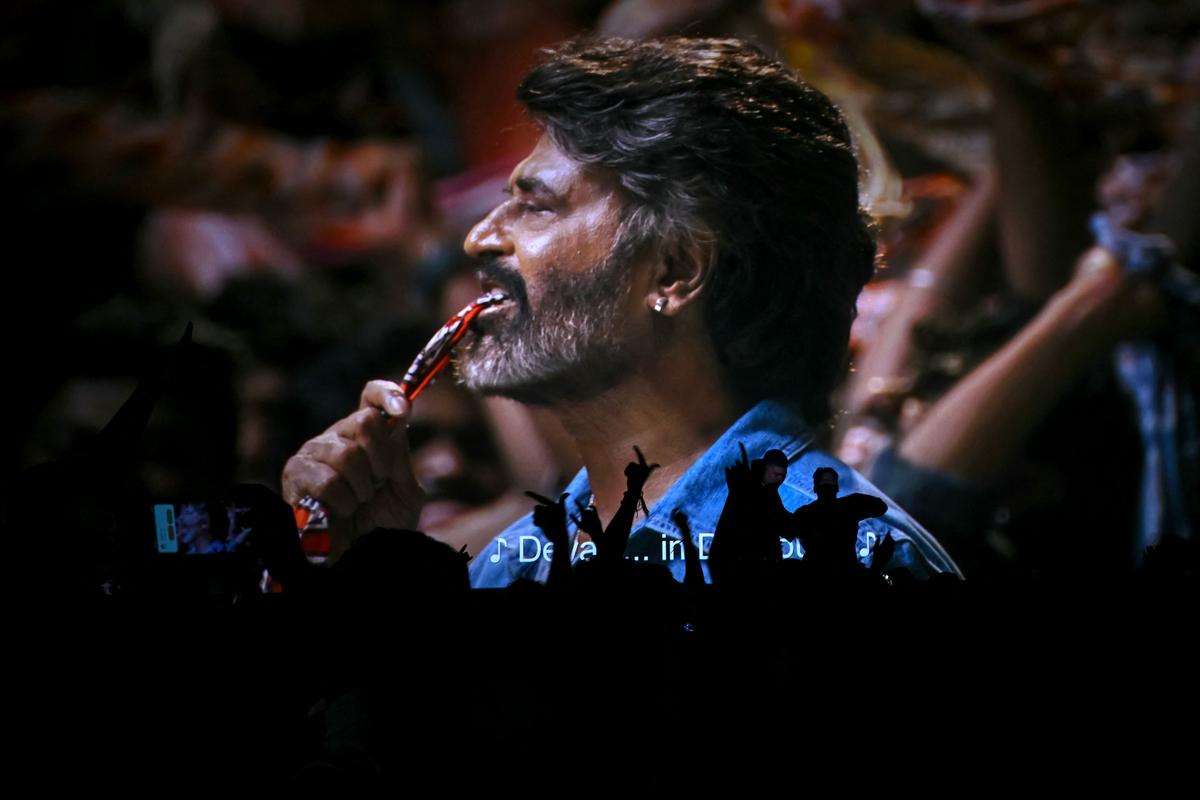 Fans dance during a screening of Rajinikanth’s Coolie Fans dance during a screening of Rajinikanth’s Coolie