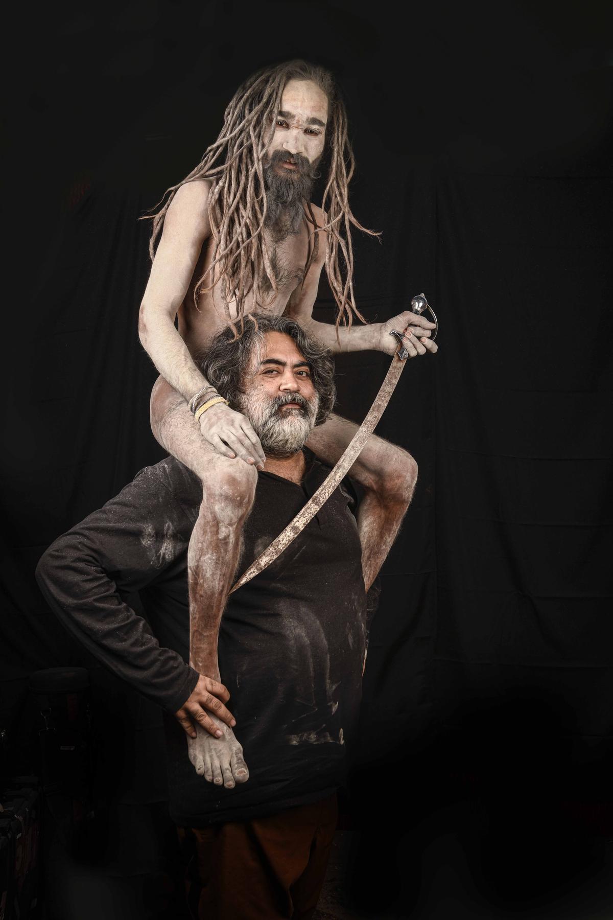 Photographer Bandeep Singh poses with a Naga sadhu