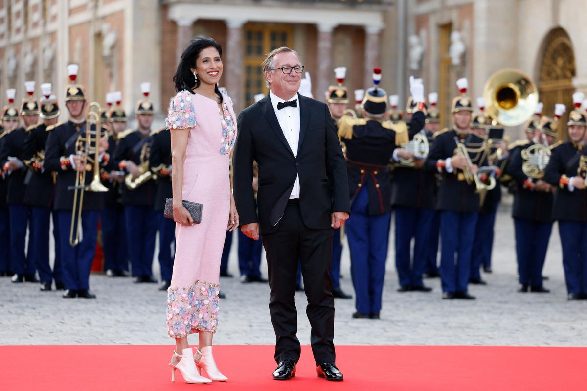 Leena Nair and Bruno Pavlovsky arrive at a state banquet at the Palace of Versailles.