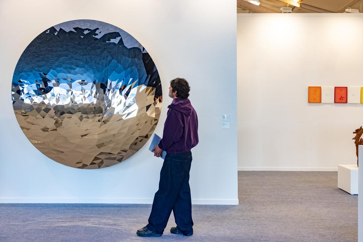 A visitor at London’s Lisson Gallery booth