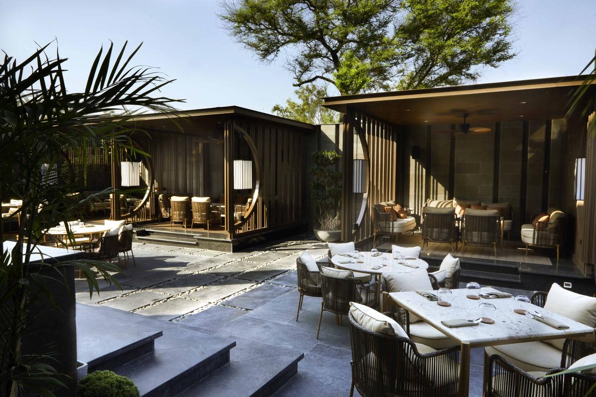 View from Shiso’s glass-walled entrance overlooking its spacious courtyard lined by gazebos