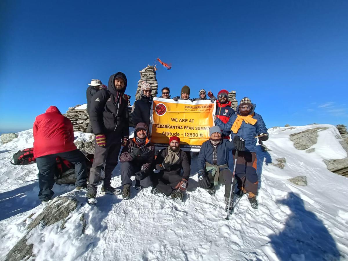 Chain Singh Rawat (with a stick in his hand) and his team of trekkers summit Kedarkantha