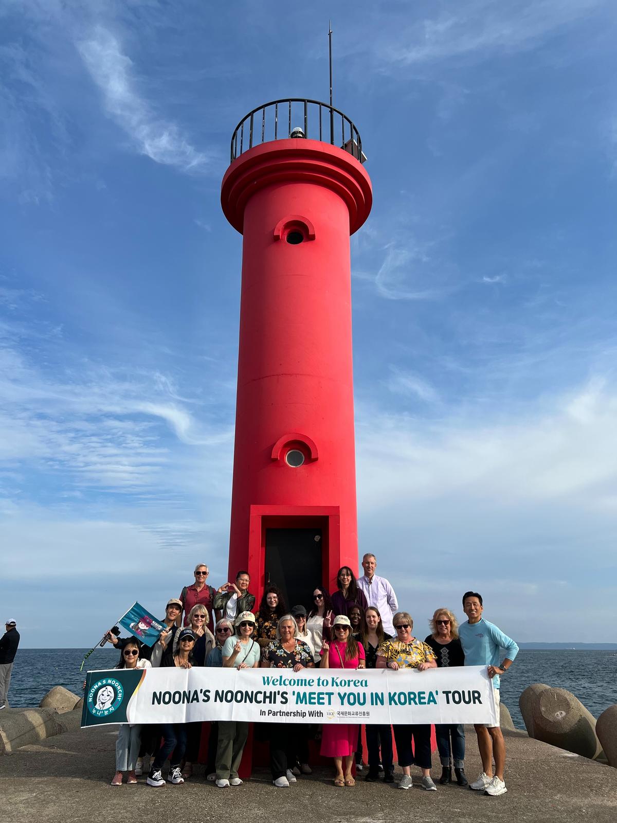 Jeanie Chang and her tour group click a picture in front of the famous lighthouse in Pohang, featured in several K-dramas including Hometown Cha Cha Cha 