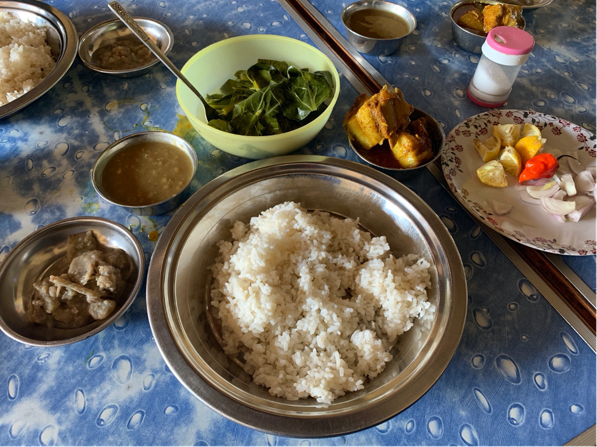 A rice meal at Mao Gate, Manipur, comprising boiled vegetables, uhti (peas cooked with soda), pork curry, and laphu (banana stem) eromba