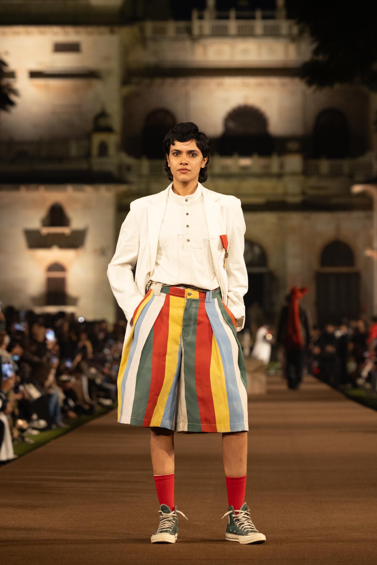 A white blazer and pachranga shorts, styled with red socks
