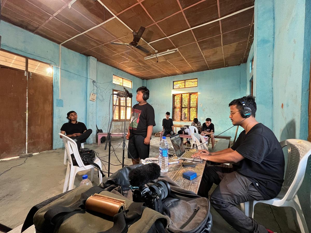 A boy sings at the makeshift studio in Phayeng