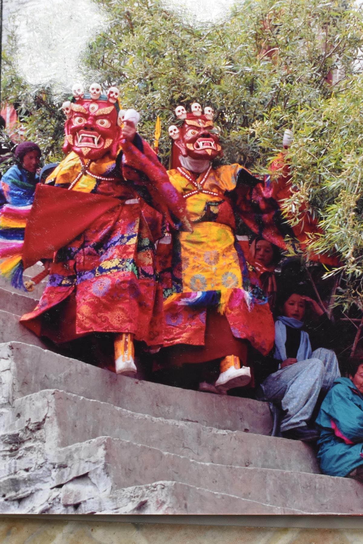 Buddhist monks in their traditional attire and masks 