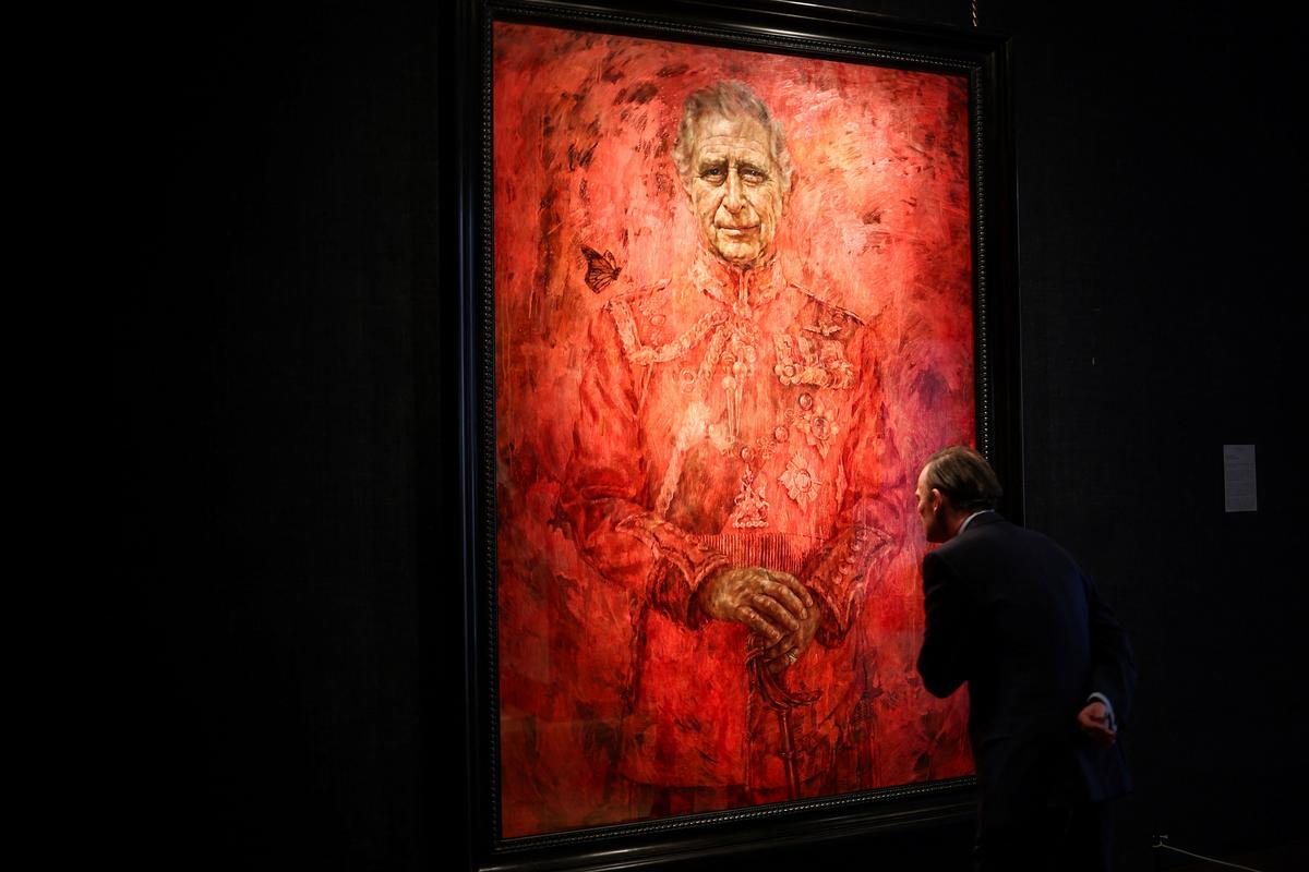 A visitor looks at the new official portrait of King Charles III, painted by Yeo, displayed at the Philip Mould gallery in London