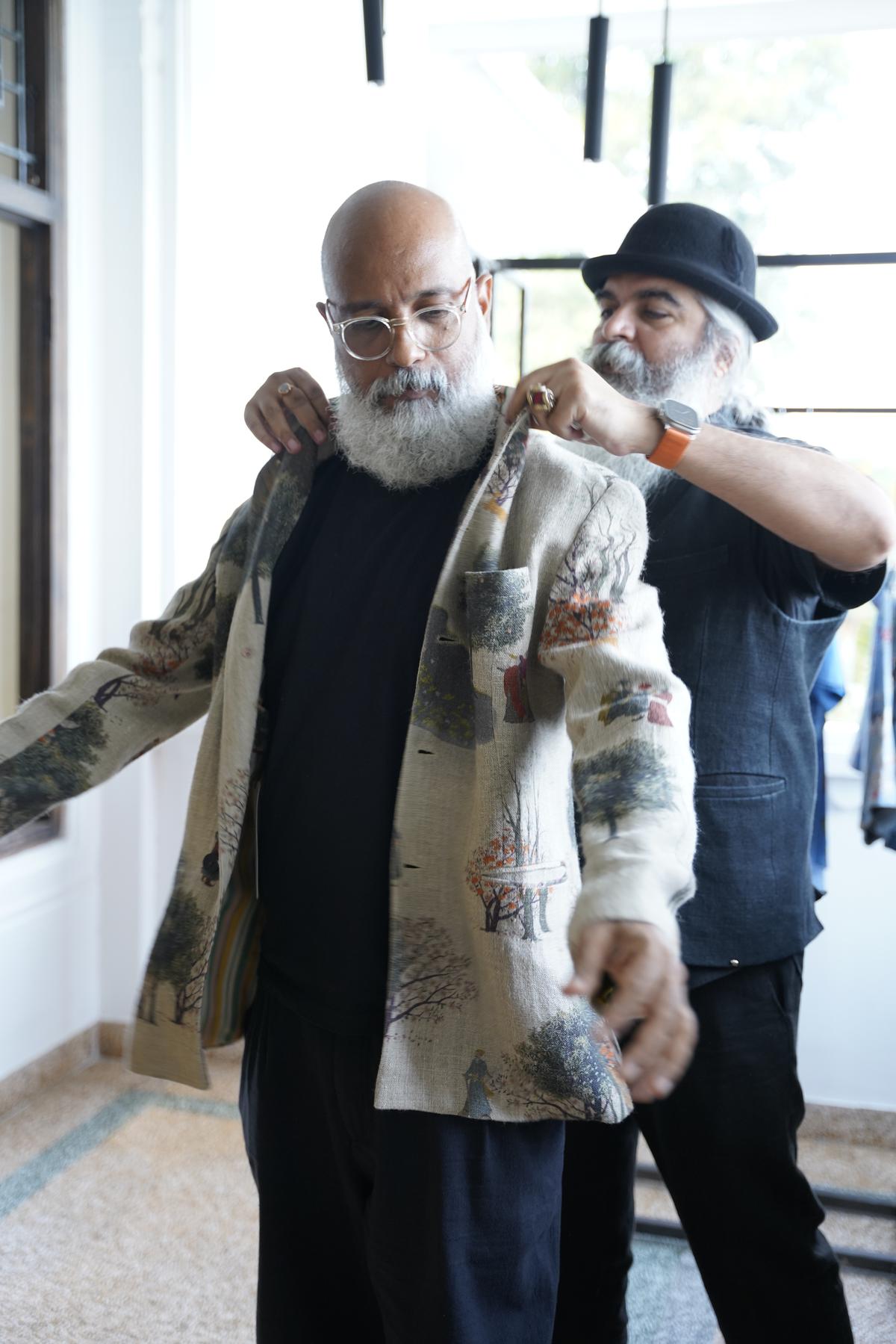 A guest tries on a piece from Suket Dhir’s collection 