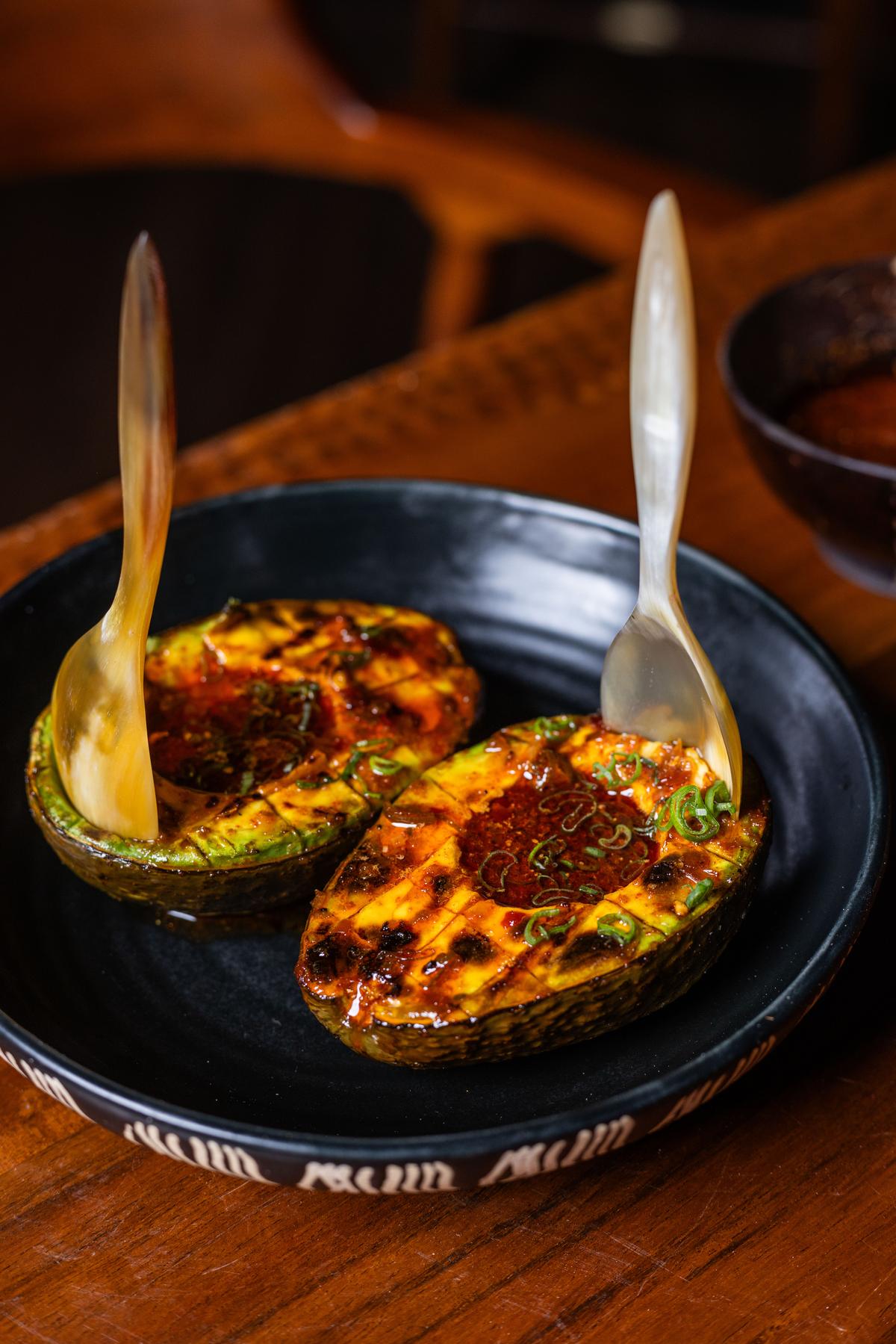 Avocado Grilled with sake yuzu kosho sauce and roasted cashew nuts 