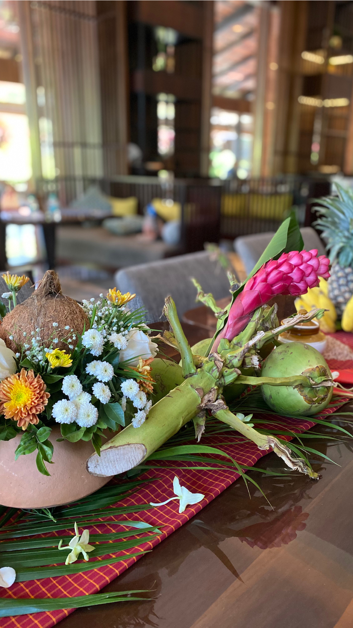 The Kunbi table runner is topped with bowls filled with dried kokum, alongside bunches of bananas, coconut and kaner flowers