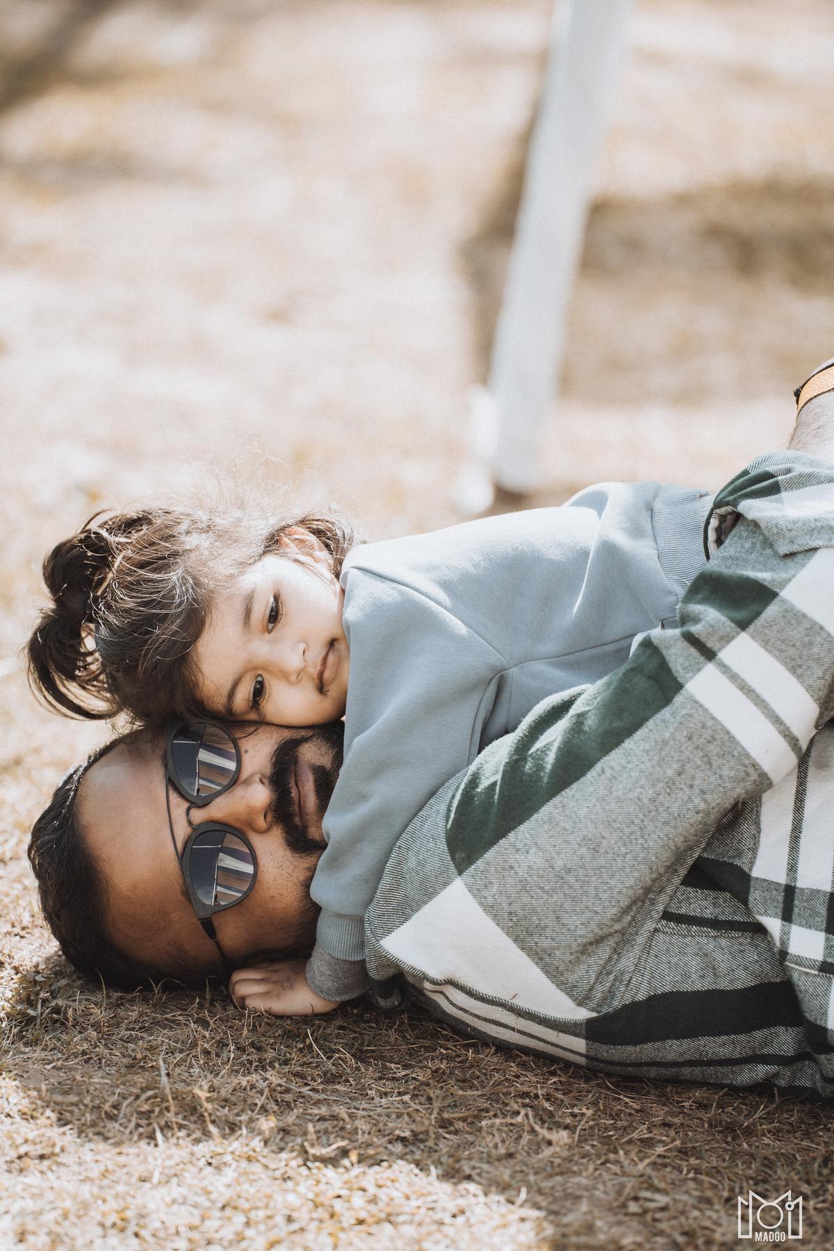 Ankit, a festival-goer, poses with his daughter Anayaa