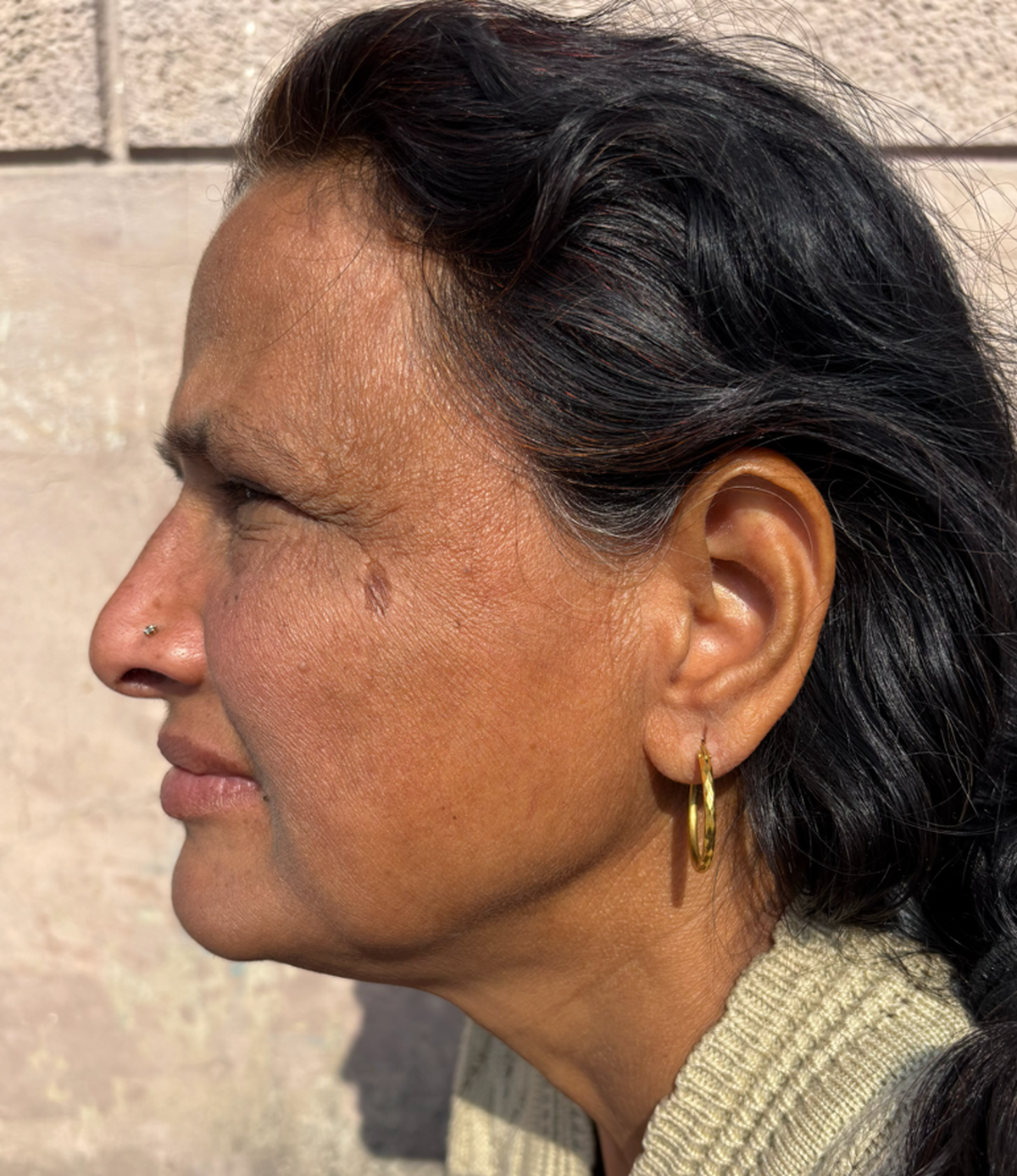 The writer’s mother wearing her thin gold hoops