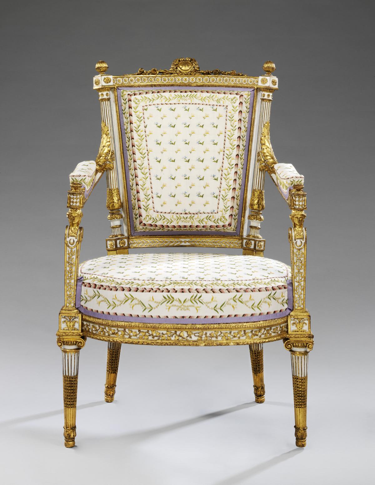Marie-Antoinette’s armchair of carved walnut, with the monogram MA in the cresting (Paris, late 1780s)