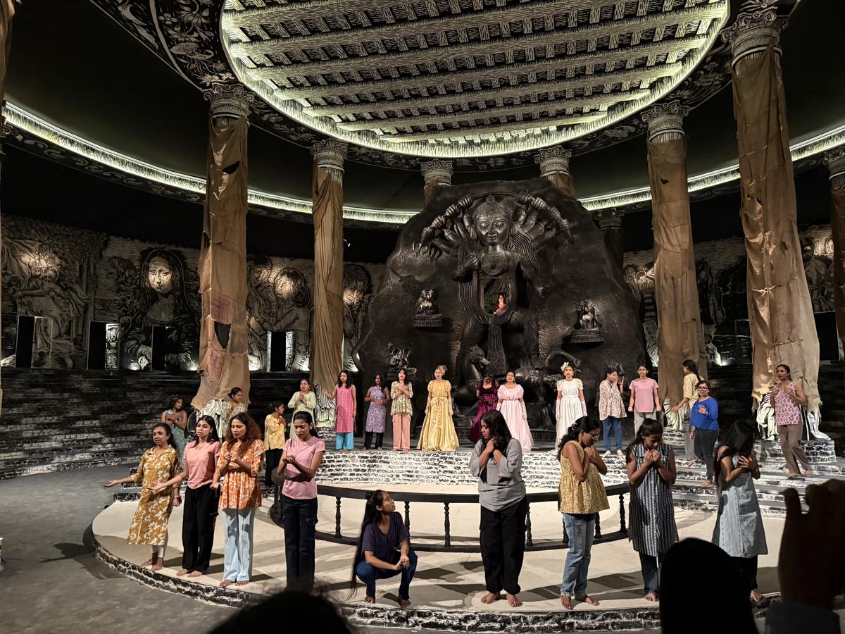A performace at the Burning pandal, with artist Anirban Das’ work as backdrop