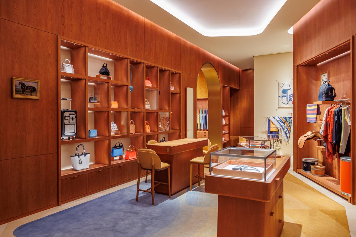 The store’s decor features the use of bamboo marquetry and deep blue walls