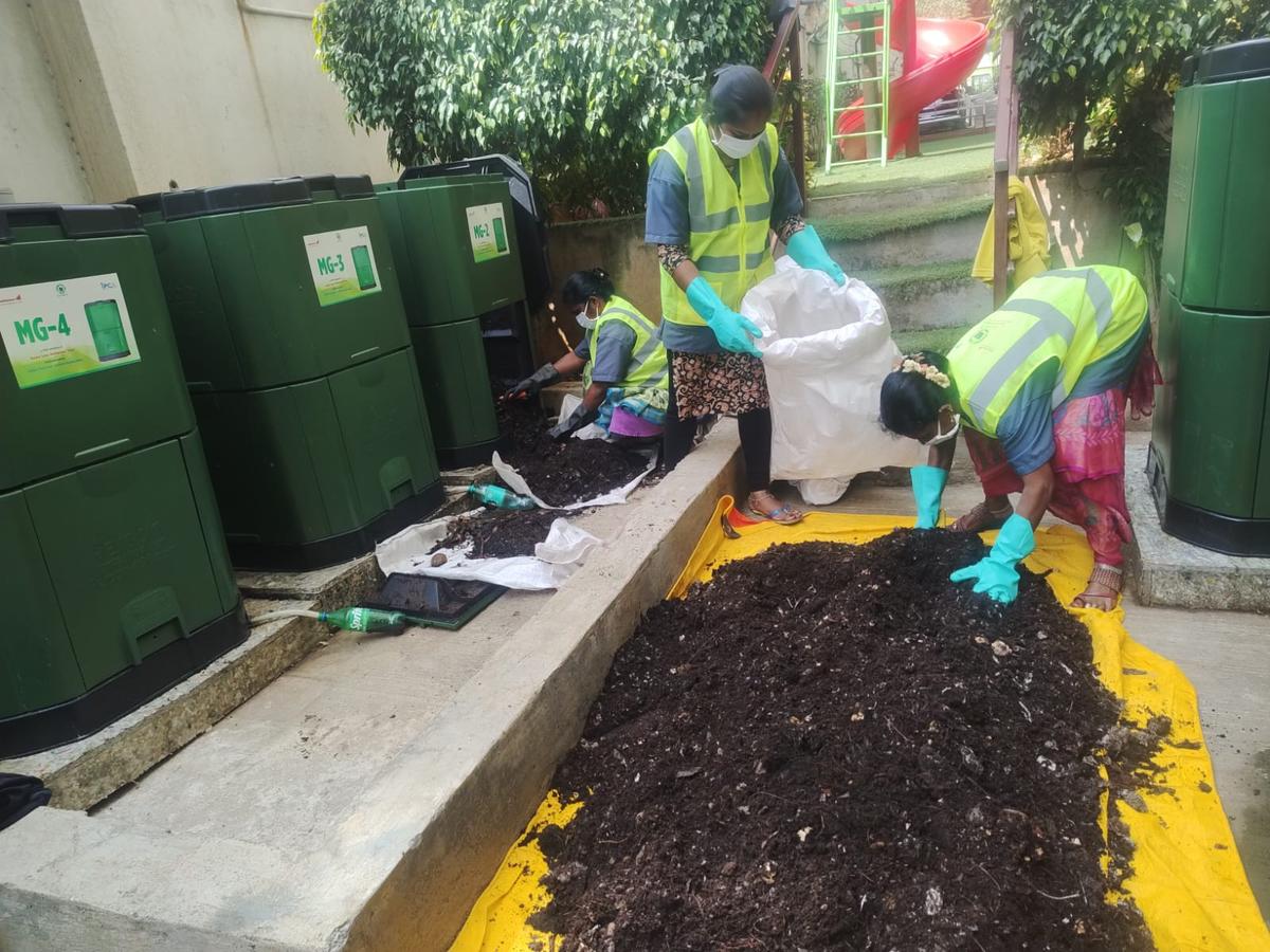 Workers setting up a waste management unit in an apartment