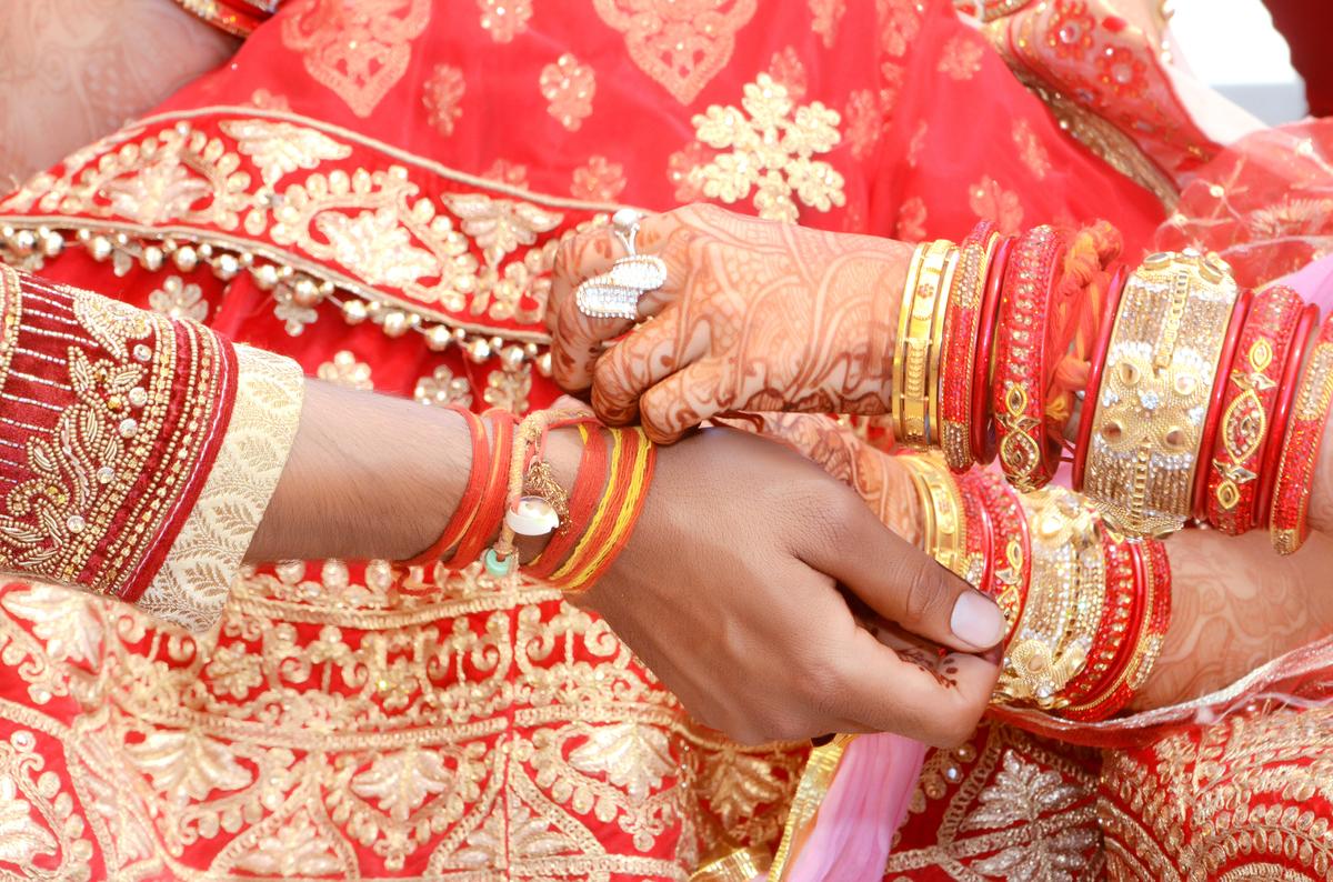 Indian couple playing Ring Fishing game in wedding ceremony of India Indian couple playing Ring Fishing game in wedding ceremony of India