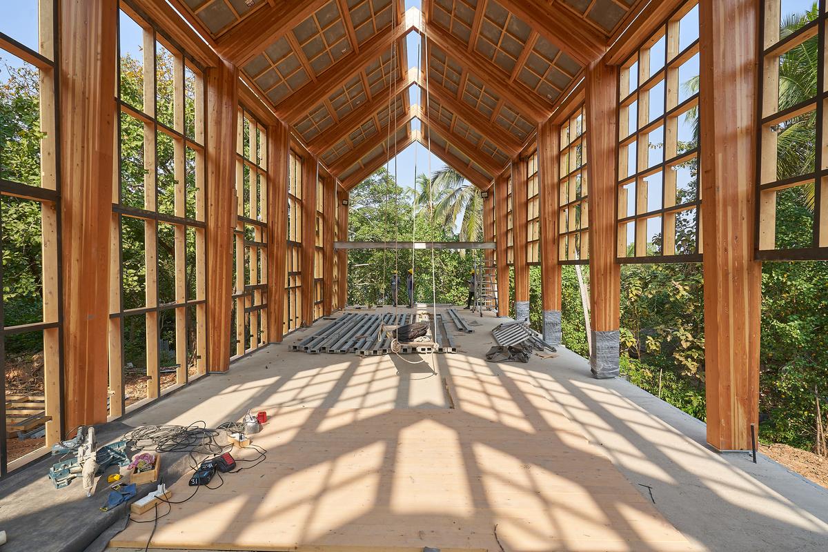 Elevated on stilts and concrete retaining walls, the house sits lightly on the site.