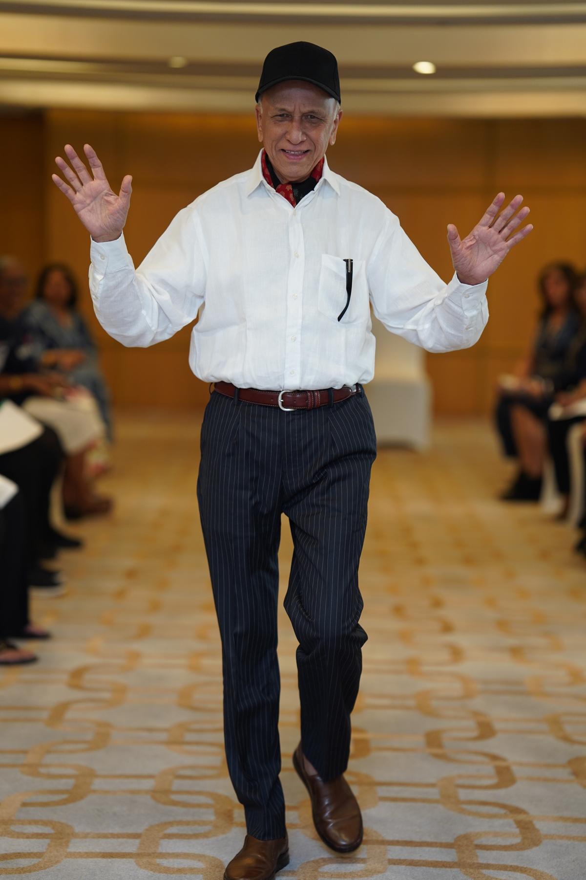 An elderly client participates in a fashion show on a trip to Goa 