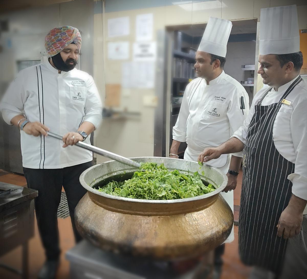 Chef Simran Singh Thapar (far left) making sarson da saag for the popup