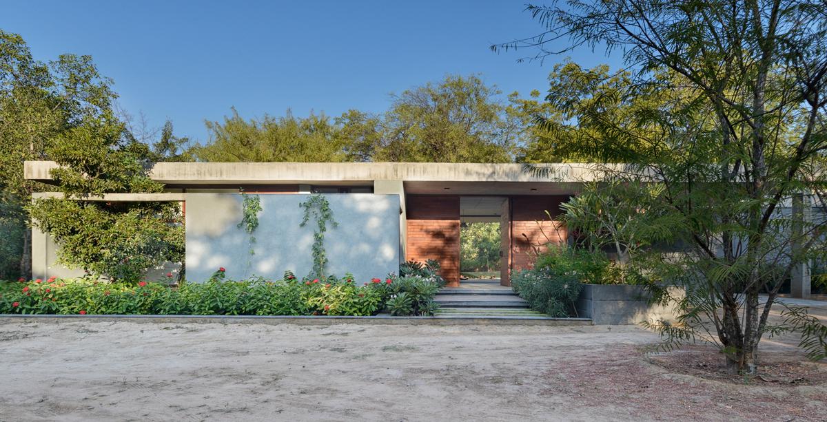 The House By The Trees was built around existing neem, chikoo, and amla trees. 