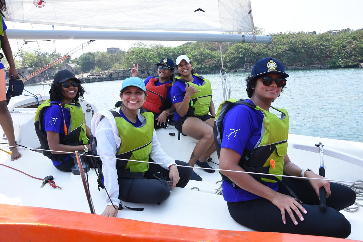 Pilots from indigo dip their feet as they sail at the chennai harbor.