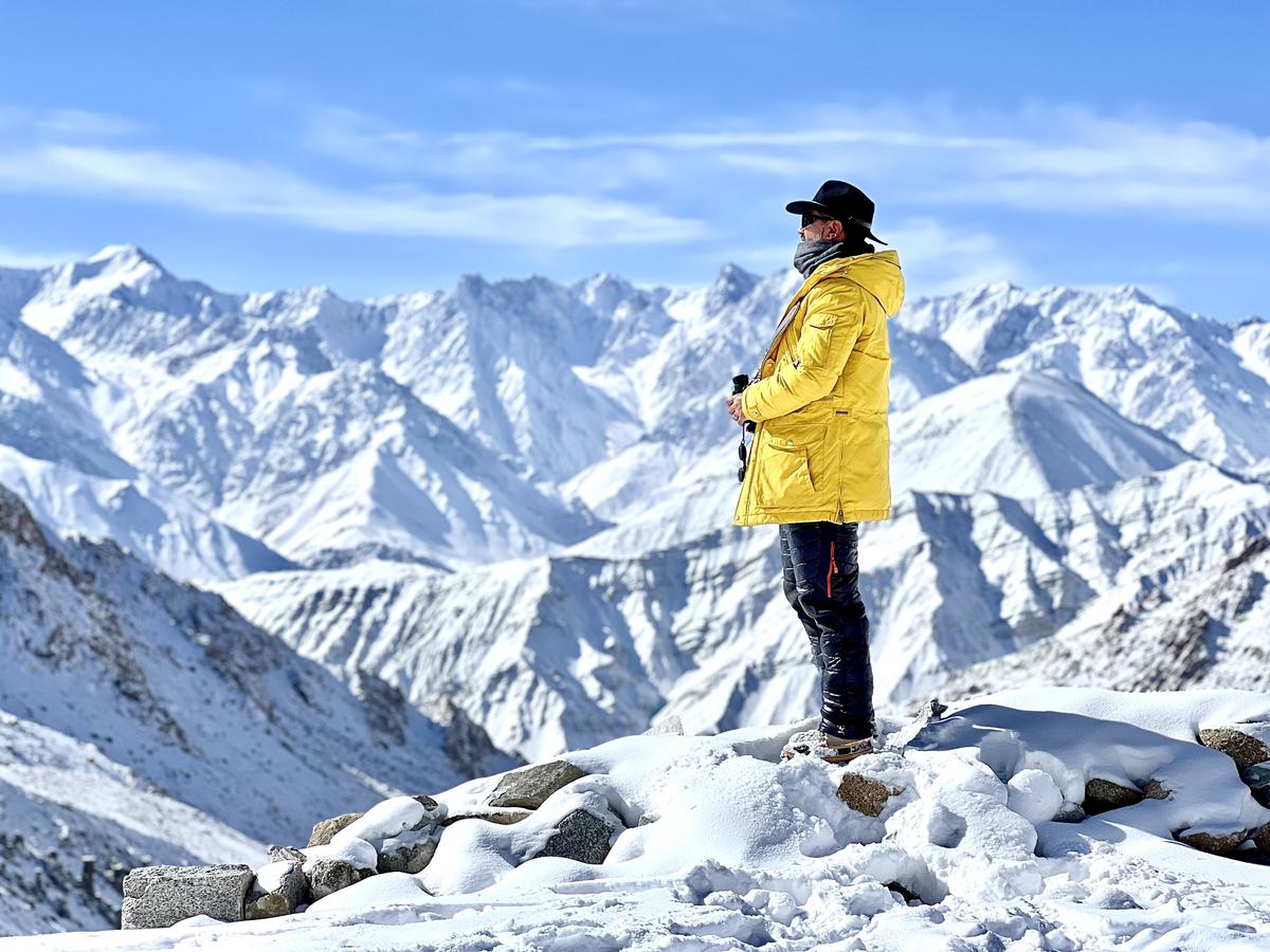 A tourist on a trail by Frozen Himalayas