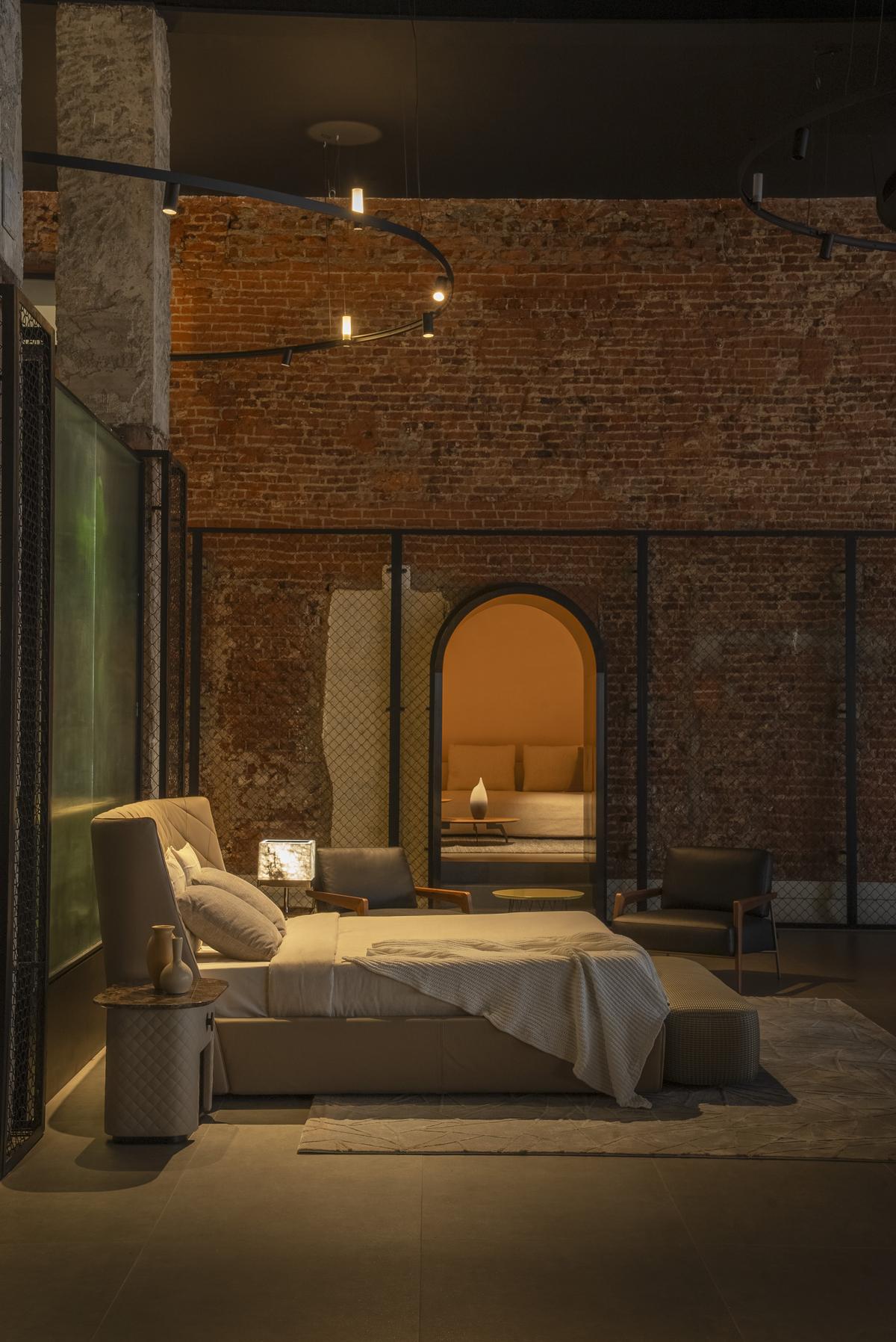 The original load-bearing brick walls were de-plastered to reveal their historical charm